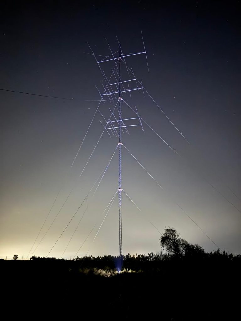 A 42-meter rotatable tower with OWA Yagis installed at night